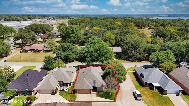 bird's eye view featuring a forest view and a residential view