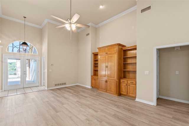 unfurnished living room featuring ceiling fan, visible vents, light wood finished floors, and ornamental molding