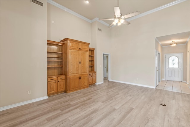 unfurnished living room featuring visible vents, light wood-style flooring, a ceiling fan, crown molding, and baseboards