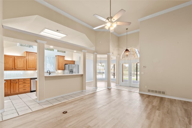 interior space featuring a sink, decorative columns, a ceiling fan, and ornamental molding