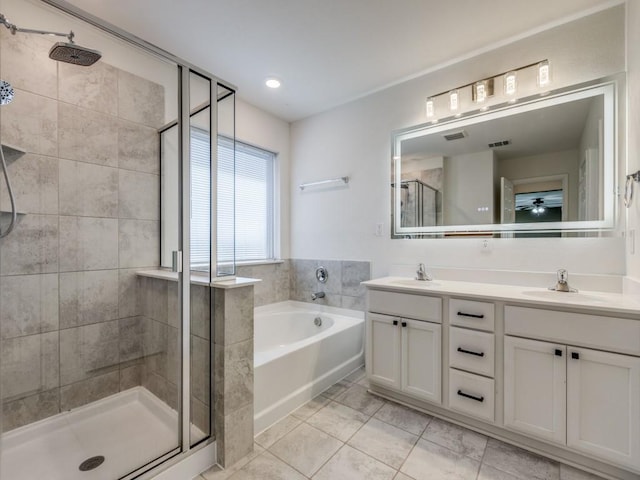 full bathroom featuring a sink, a stall shower, double vanity, and a bath