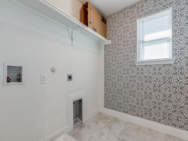 clothes washing area with baseboards, hookup for an electric dryer, hookup for a washing machine, and laundry area