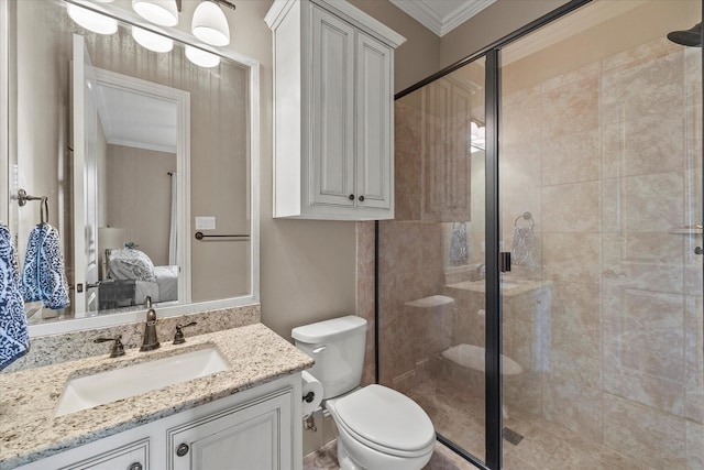 ensuite bathroom featuring a stall shower, toilet, vanity, and ornamental molding