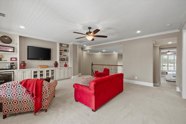 carpeted living area with recessed lighting, baseboards, a ceiling fan, and ornamental molding