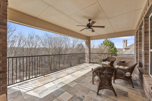 view of patio with a balcony, an outdoor hangout area, and a ceiling fan