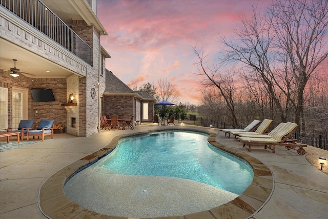 view of pool featuring a fenced in pool, fence, ceiling fan, and a patio area