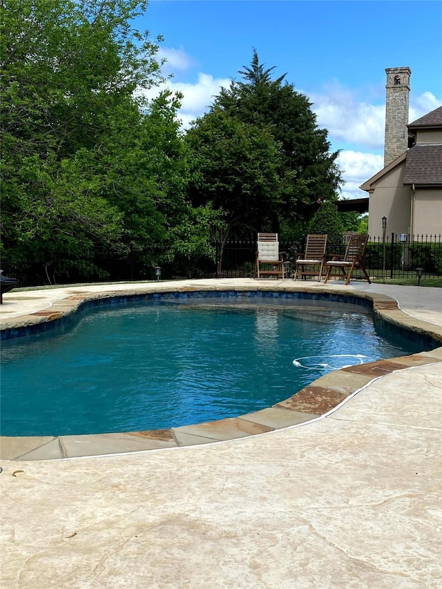 view of swimming pool featuring a fenced in pool, a patio, and fence