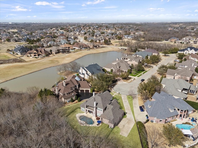 bird's eye view featuring a residential view and a water view