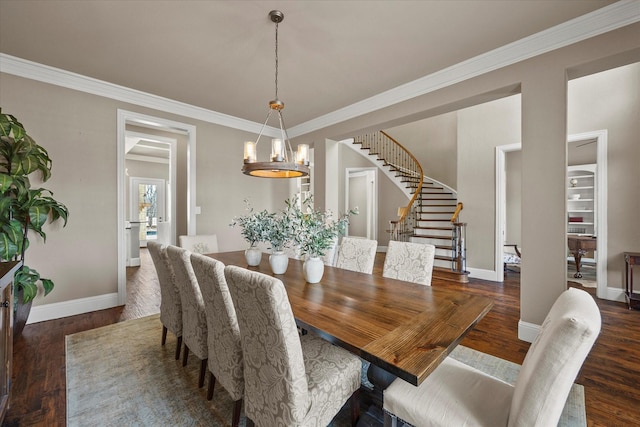 dining space featuring stairs, an inviting chandelier, wood finished floors, and baseboards