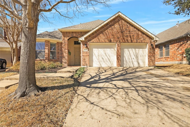 ranch-style home with an attached garage, brick siding, driveway, and a shingled roof