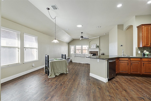 kitchen featuring dark countertops, dark wood-style floors, a fireplace, and visible vents