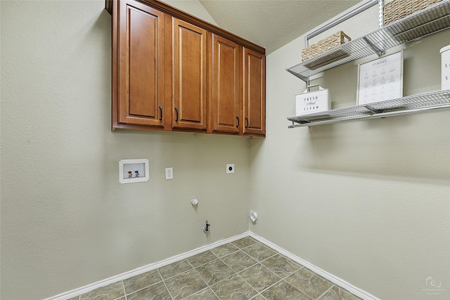 washroom featuring baseboards, washer hookup, hookup for a gas dryer, cabinet space, and electric dryer hookup