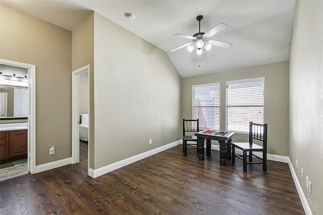 sitting room with dark wood-style flooring, baseboards, ceiling fan, and vaulted ceiling