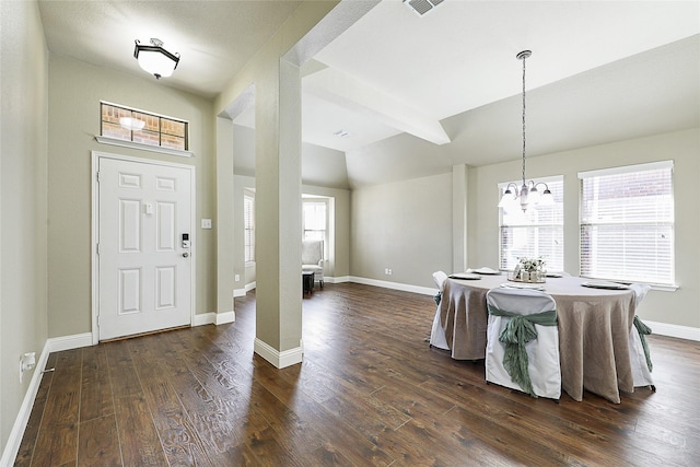 entryway with baseboards, a notable chandelier, dark wood finished floors, and vaulted ceiling