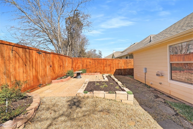 view of yard with a garden and a fenced backyard