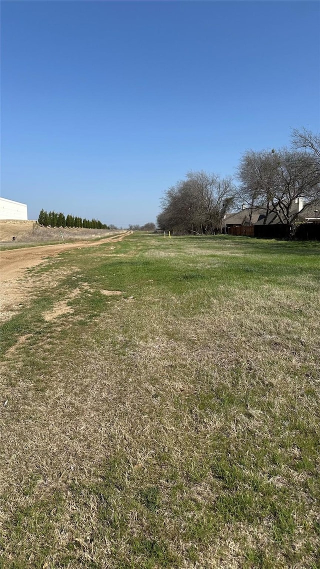 view of yard with a rural view