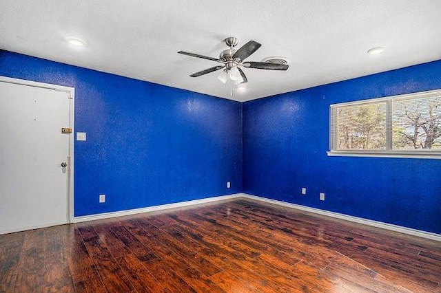 spare room with a textured wall, baseboards, ceiling fan, and wood finished floors