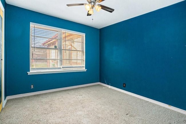 unfurnished room with a ceiling fan, baseboards, and carpet floors