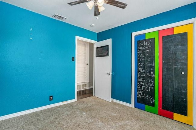 unfurnished bedroom with a ceiling fan, baseboards, visible vents, a closet, and carpet flooring