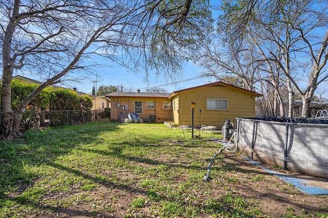 view of yard with a fenced in pool and fence