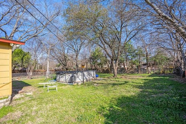 view of yard with fence and a fenced in pool