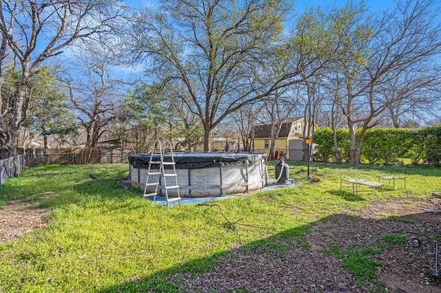 view of yard with a fenced in pool and fence