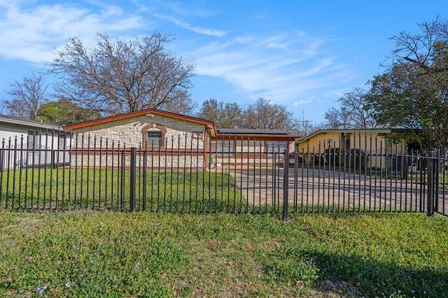 exterior space with a fenced front yard and a gate