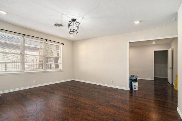 spare room with recessed lighting, wood finished floors, visible vents, and baseboards