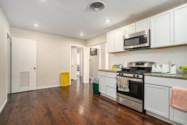 kitchen featuring visible vents, appliances with stainless steel finishes, dark wood-style flooring, and white cabinetry