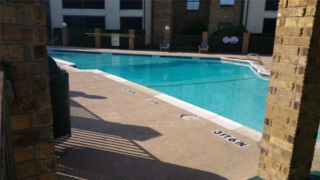 community pool featuring fence