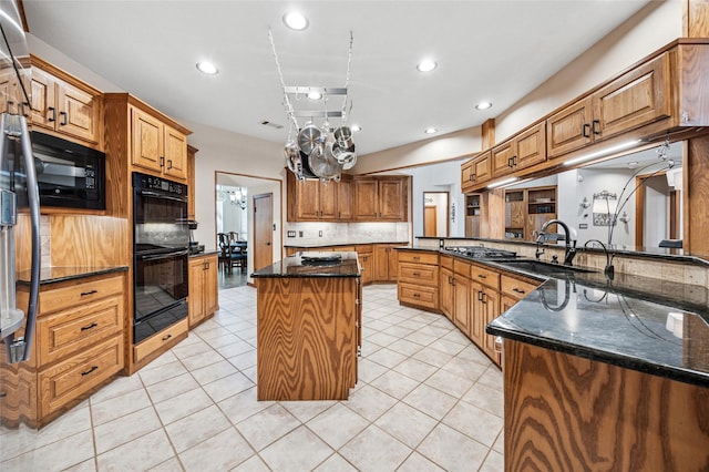 kitchen with black appliances, a sink, a center island, recessed lighting, and light tile patterned floors