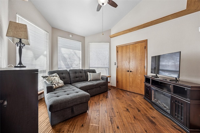 living area featuring vaulted ceiling, hardwood / wood-style flooring, and a ceiling fan