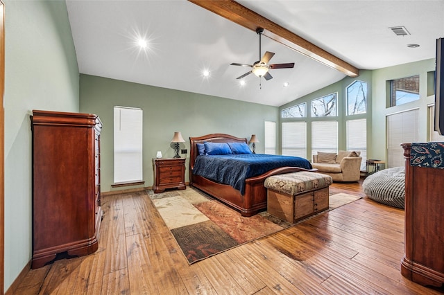 bedroom with visible vents, beam ceiling, high vaulted ceiling, a ceiling fan, and hardwood / wood-style floors