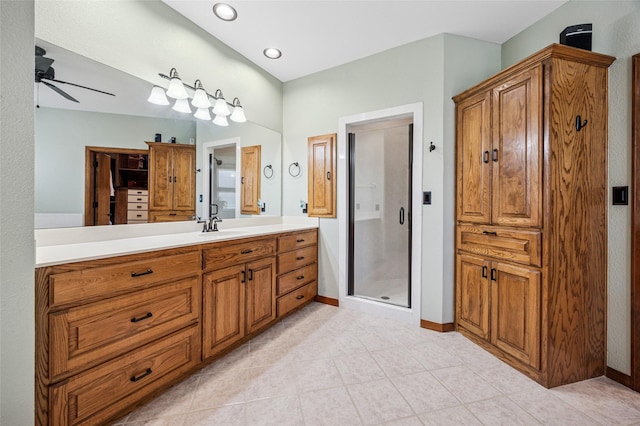 bathroom featuring baseboards, ceiling fan, a stall shower, tile patterned floors, and vanity