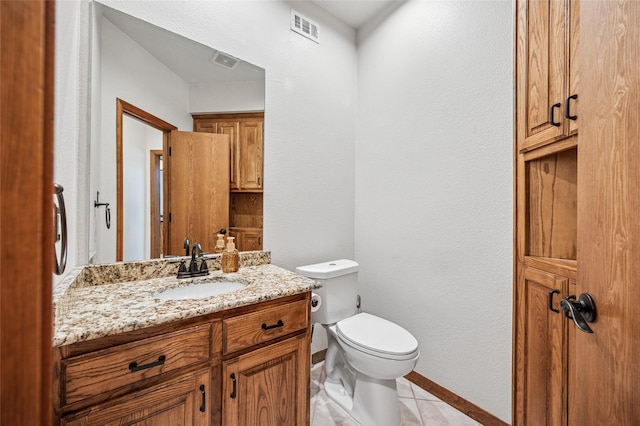 bathroom featuring visible vents, toilet, vanity, and tile patterned flooring