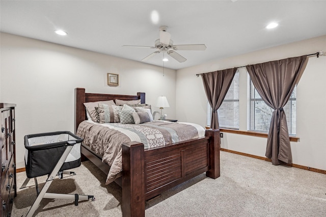 bedroom featuring a ceiling fan, recessed lighting, light colored carpet, and baseboards