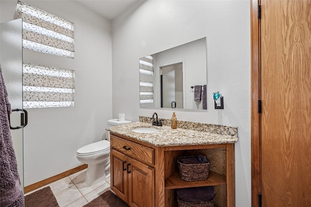 bathroom featuring tile patterned flooring, toilet, vanity, and baseboards