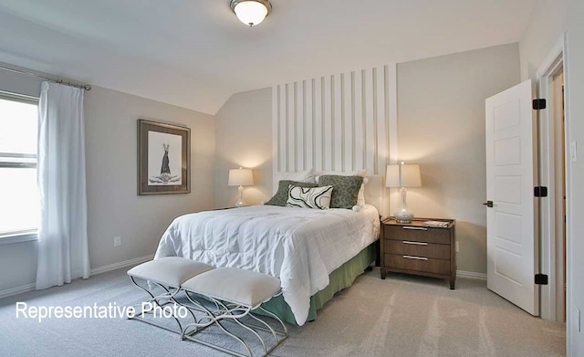 bedroom with baseboards, multiple windows, and light colored carpet