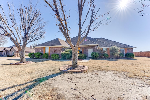 ranch-style house with fence and brick siding