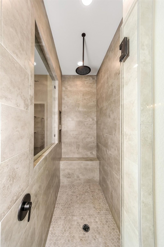 bathroom with tiled shower