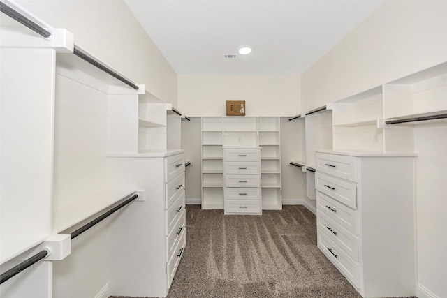 spacious closet featuring visible vents and dark carpet