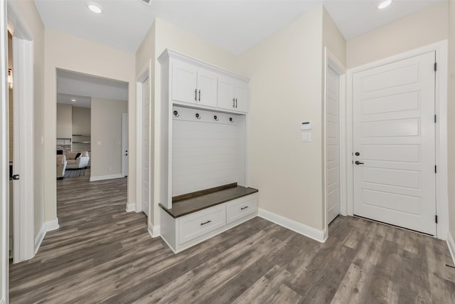 mudroom featuring recessed lighting, baseboards, and dark wood-type flooring