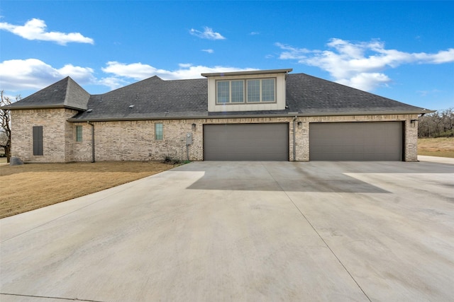 view of front of house featuring brick siding, driveway, a shingled roof, and a front lawn