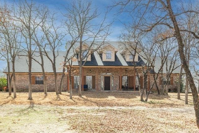 cape cod-style house with brick siding