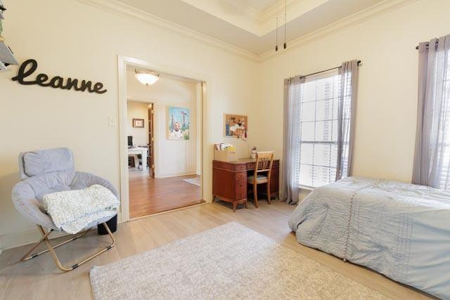 505 Spring Valley Rd, Paradise, TX 76073 - bedroom featuring wood finished floors, a raised ceiling, and crown molding