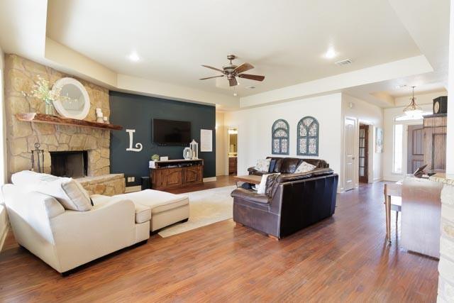 505 Spring Valley Rd, Paradise, TX 76073 - living room featuring ceiling fan, wood finished floors, visible vents, and a raised ceiling