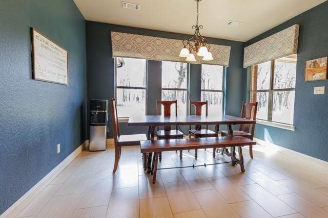 505 Spring Valley Rd, Paradise, TX 76073 - dining area with a chandelier, a textured wall, visible vents, and baseboards