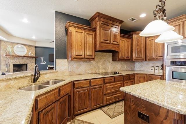 505 Spring Valley Rd, Paradise, TX 76073 - kitchen with built in microwave, backsplash, a sink, light stone countertops, and stainless steel oven