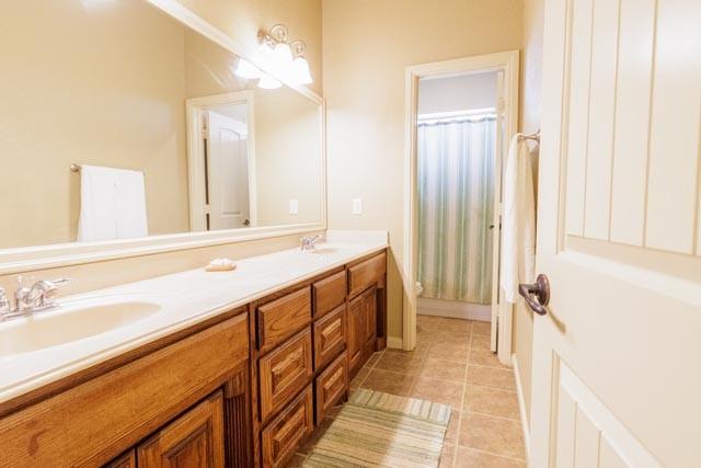 505 Spring Valley Rd, Paradise, TX 76073 - full bath with double vanity, tile patterned flooring, toilet, and a sink