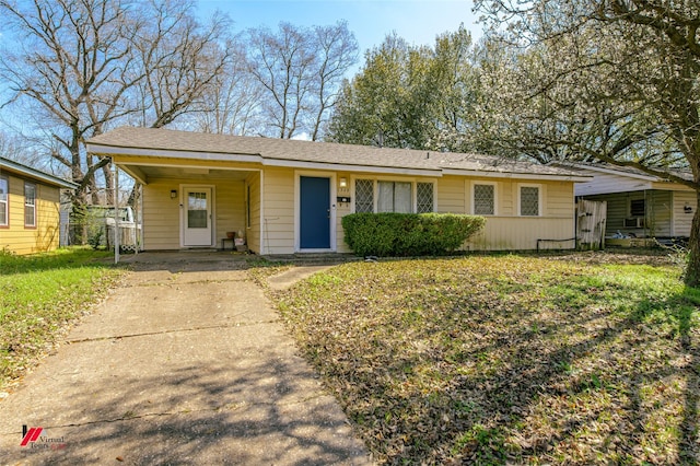 single story home with a carport, driveway, a front yard, and fence